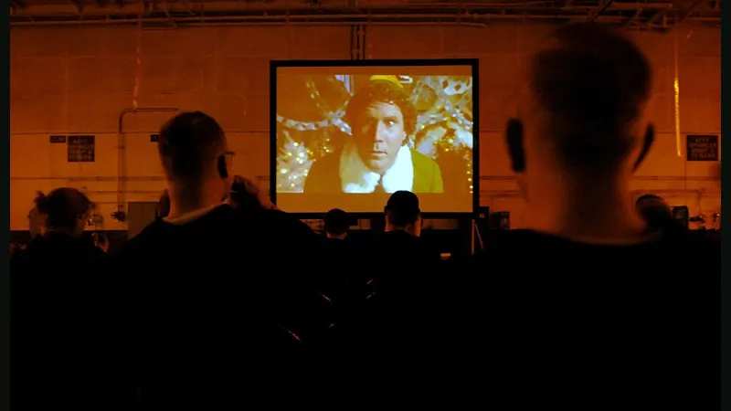 Viewers watching a film together on a screen